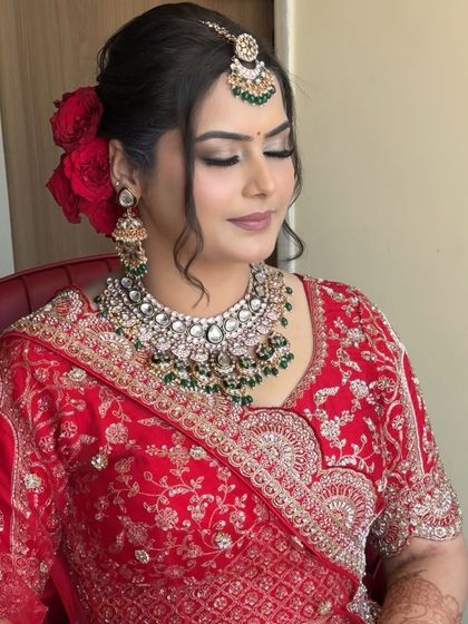 A soft, elegant profile. The red roses in her hair add a touch of romance, while the closed-eye pose shows off the delicate eyeshadow work and perfectly defined brows.