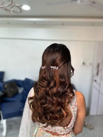 Another angle showing the soft, bouncy curls in this half-up style, perfect for an engagement or Roka ceremony.