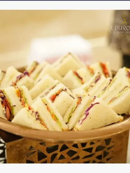 For daytime events or corporate lunches, I offer classic vegetable club sandwiches. They are neatly cut and arranged on a platter for easy and elegant self-service.