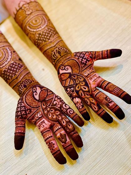 This bridal design was customized with the bride's favorite element: a proud peacock. I love incorporating personal touches to make your mehendi truly yours.