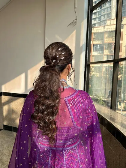 The sunlight catching the details of this beautiful Sangeet hairstyle. The client is ready to dance the night away.