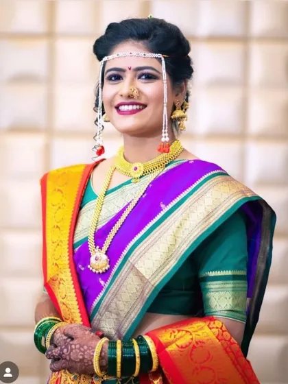 Another beautiful Marathi bride, smiling and radiant on her big day. The makeup is designed to last through all the ceremonies while looking fresh.