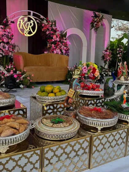 A view of the offering table with the modern arched backdrop and custom monogram.