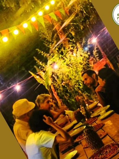 Guests deep in conversation during a farm dinner. We foster a sense of community and connection at all our events.