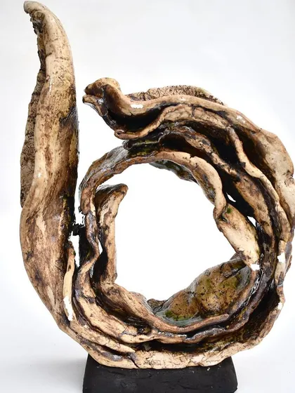 The same swirling sculpture, viewed from the front. The central opening invites you to look through and beyond.
