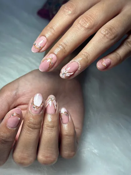 A beautiful view of this intricate bridal design. The 3D floral element on the ring finger adds a lovely texture and focus point to the manicure.