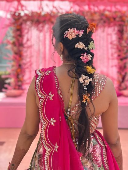 The bride is ready for her Haldi ceremony with this stunning floral braid that matches the festive decor perfectly.
