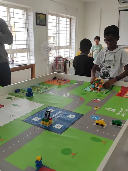 A student makes final adjustments to his robot during a competition at our North Bangalore center. The challenge was to program an autonomous school bus to complete several tasks.