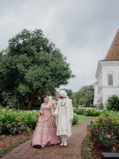 A beautiful shot of the couple. Her pastel pink lehenga and soft makeup create a romantic, fairytale-like vision.