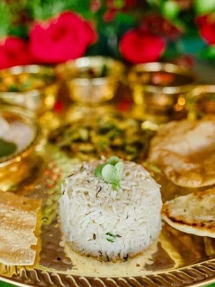 A close-up of the perfectly cooked jeera rice and assorted breads, essential components of our traditional Indian feast.