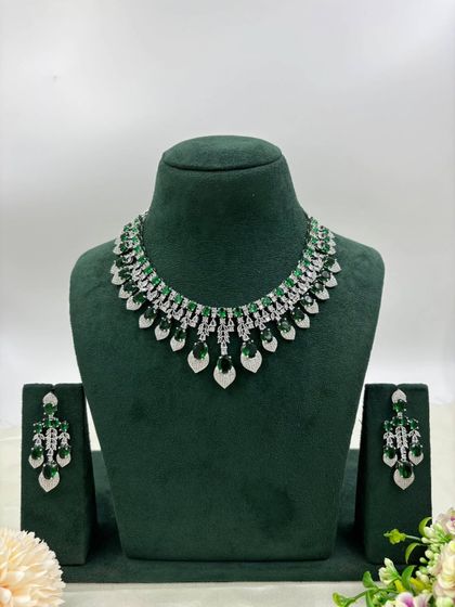 A delicate silver-plated AD necklace with a fringe of leaf-shaped stones. This design is available in mint green, white, and a two-tone pink and green, offering a fresh and modern aesthetic.