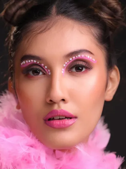 A direct shot showing the precise application of the graphic liner and gems.