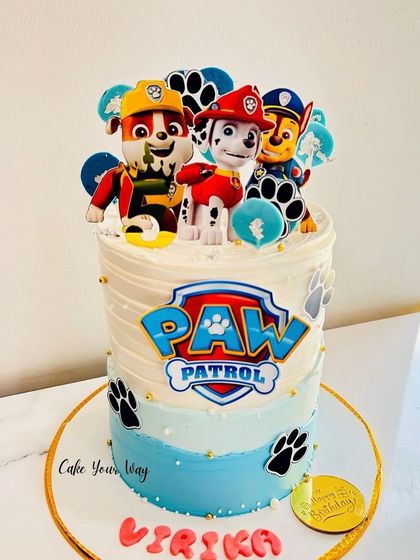 One of my most-loved Paw Patrol designs, this tall cake features the heroic pups on a blue and white striped background.