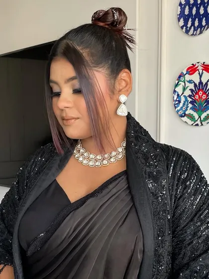 The front view of the glitter top knot, with soft tendrils framing the face. This shows how an edgy style can still be soft and flattering.