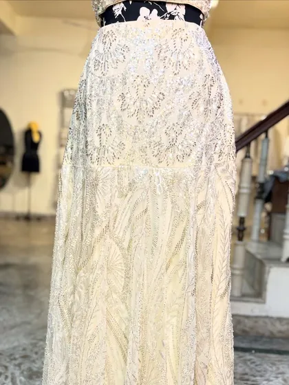 A detailed shot of the intricate beadwork on the skirt of the 'APSARA' lehenga.