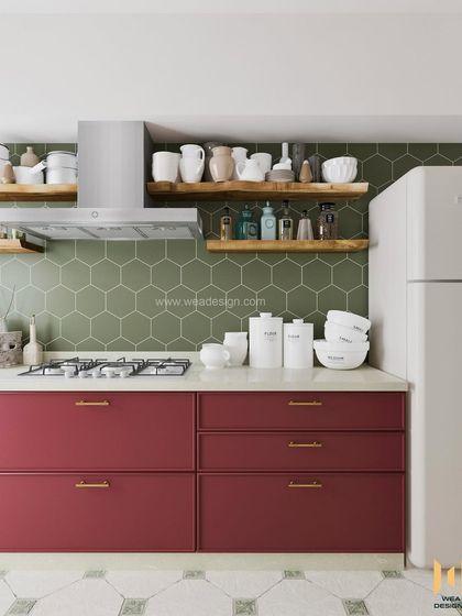 This kitchen design uses a bold magenta on the lower cabinets, balanced with a green hexagonal tile backsplash and open live-edge wood shelves for a unique, eclectic look.