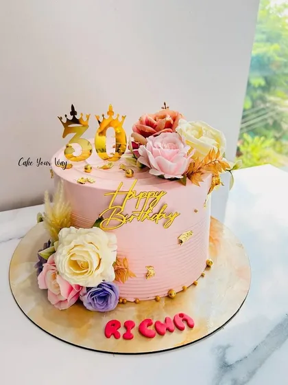 Golden moments and blooming memories on this beautiful pink floral cake for a 30th birthday.
