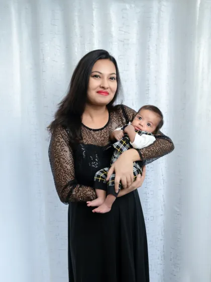 A mother holds her alert and curious newborn boy. We love capturing those moments when your baby starts to look at the world around them.