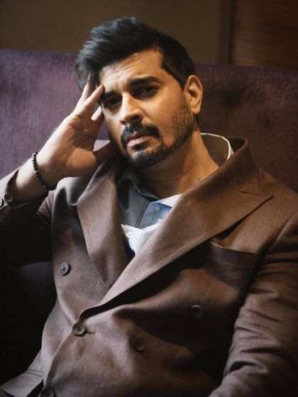 A close-up portrait of Tahir Raj Bhasin, looking directly at the camera. His expression is intense and engaging, drawing the viewer in.