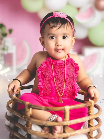 A sweet portrait from a watermelon-themed first birthday. This little girl looks so adorable sitting in a rustic basket.