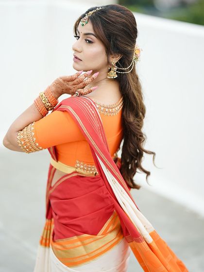 A graceful side profile that gives another glimpse of the simple henna, perfectly matching her elegant attire.