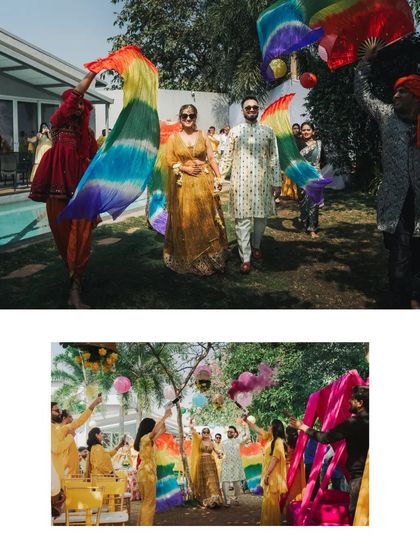 The couple's grand entrance, walking through a line of friends waving colorful rainbow flags.