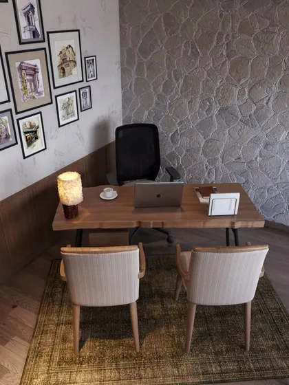 A close-up of the workspace reveals the rich texture of the stone wall and the natural grain of the wooden desk. We believe in using honest, tactile materials to create spaces that feel authentic and inspiring.