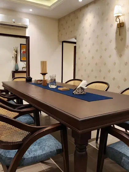 A different perspective of our minimal dining room project. This view highlights the elegant patterned wallpaper and the strategic use of mirrors to create a sense of spaciousness, proving that a room can be both simple and full of character.