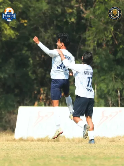 Celebrating a goal. The passion and excitement are clear as teammates congratulate the scorer.
