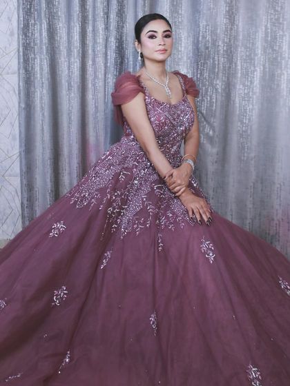 A closer seated portrait that shows the detail on the bodice and the soft tulle of the sleeves.