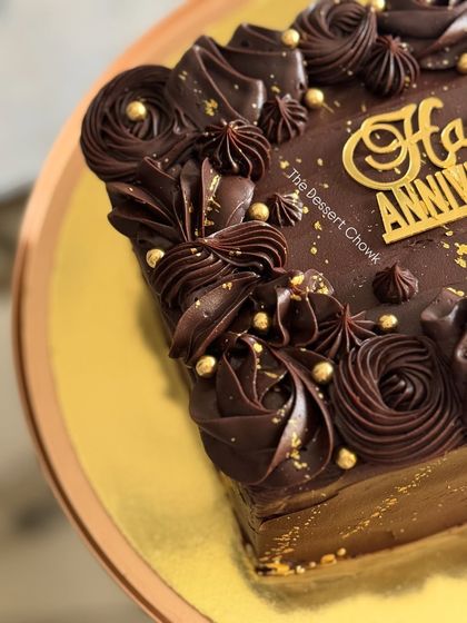 My Truffle Nutty Delight cake, a rich chocolate sheet cake perfect for an anniversary, with beautiful piping and a sprinkle of edible gold.