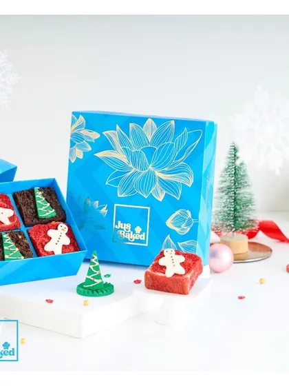 Our mini celebration box gets a festive makeover for Christmas, filled with adorable gingerbread-themed brownies.