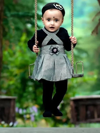 The simple joy of a swing ride. This photo is from a fun and candid toddler photoshoot, where the focus is on capturing genuine expressions and playful moments.
