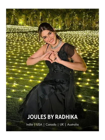 Spreading love and light. Kriti Sanon makes a heart gesture, her joyful moment accentuated by our elegant couture jewelry.