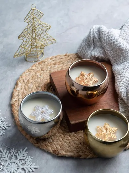 These metallic jar candles are a modern take on Christmas decor. I pour scented wax into these beautiful gold, silver, and rose gold bowls, each with a little snowflake wax melt on top.