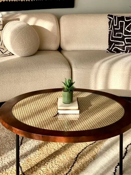 Another angle of our popular rattan and wood center table, showing how it pairs with a modern sofa.