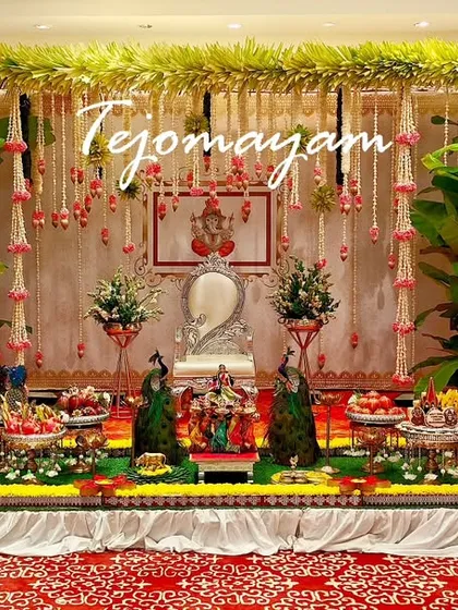 A Half-Saree ceremony setup with a backdrop of banana plants and hanging garlands, creating a very traditional and auspicious look.
