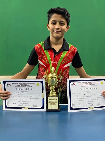 Atharva with his certificates and trophy from the state championships.