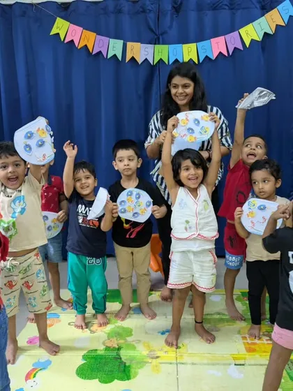 The proud creators holding up their artwork after a storytelling session. Every session ends with a hands-on activity, allowing children to express their understanding of the story through art.