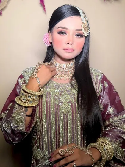 This pose captures the full essence of the traditional look, from the outfit to the intricate hand jewelry.