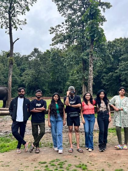 A group of our travelers posing with an elephant in the background at a camp near the forest. These interactions are a memorable part of the trip.