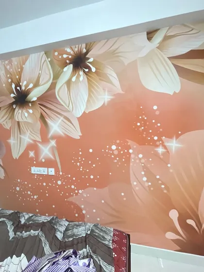 A finished installation of a custom floral wallpaper in a peachy-orange hue, complete with sparkling glitter effects that catch the light.