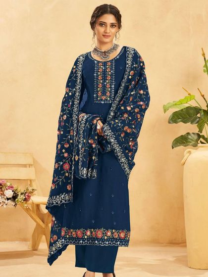 A classic blue salwar kameez with a beautifully embroidered floral dupatta. It's a versatile piece that can be dressed up or down for any event.