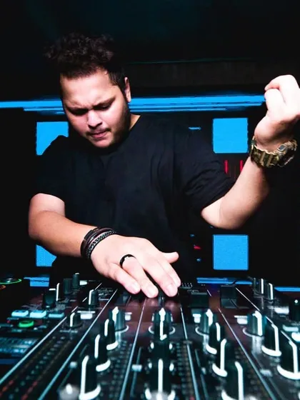 In the mix, signaling to the crowd. A classic DJ pose that shows I'm in control and feeling the music.