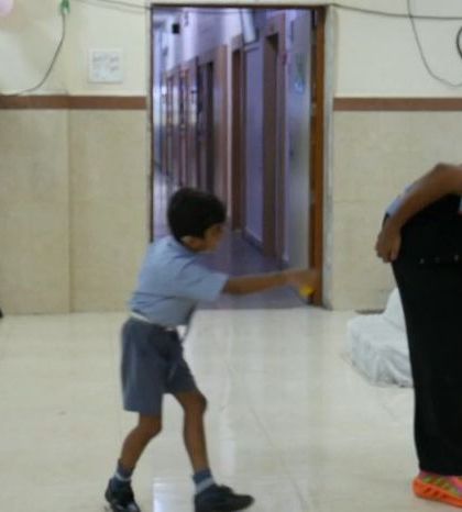 A child playfully interacts with the 'Silent Storyteller' on stage. Our sessions encourage participation and self-expression, creating a fun and liberating atmosphere.