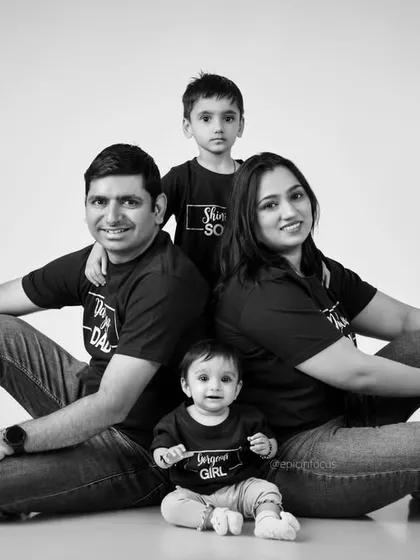 A modern family portrait with everyone dressed in matching black shirts. This fun, coordinated look creates a strong and unified family photo.