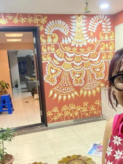A happy selfie with the nearly completed 'Ethnic Ether Mural.' The design is inspired by Indian celebratory decorations and is meant to bring a feeling of joy and abundance to the home's entrance.