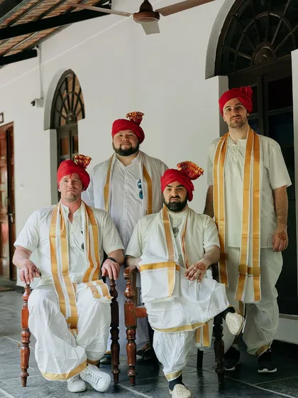 Groomsmen from abroad looking regal in traditional Indian turbans and attire for their friend's wedding.