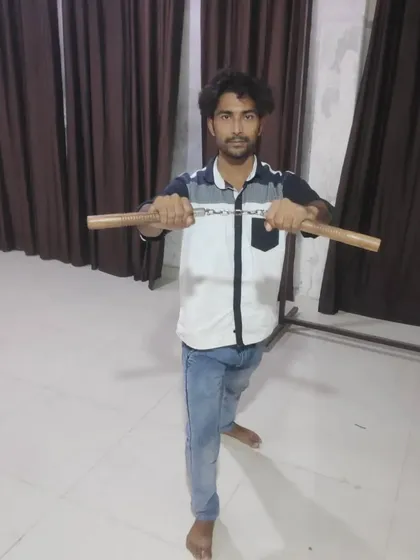 My student Mohd Farman holding the nunchucks. He is learning to handle this difficult weapon, building discipline and focus with every practice session.