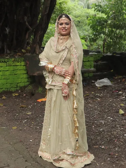 A full view of the traditional Rajasthani bridal attire. The makeup is kept elegant to complement the heavy outfit and jewelry.